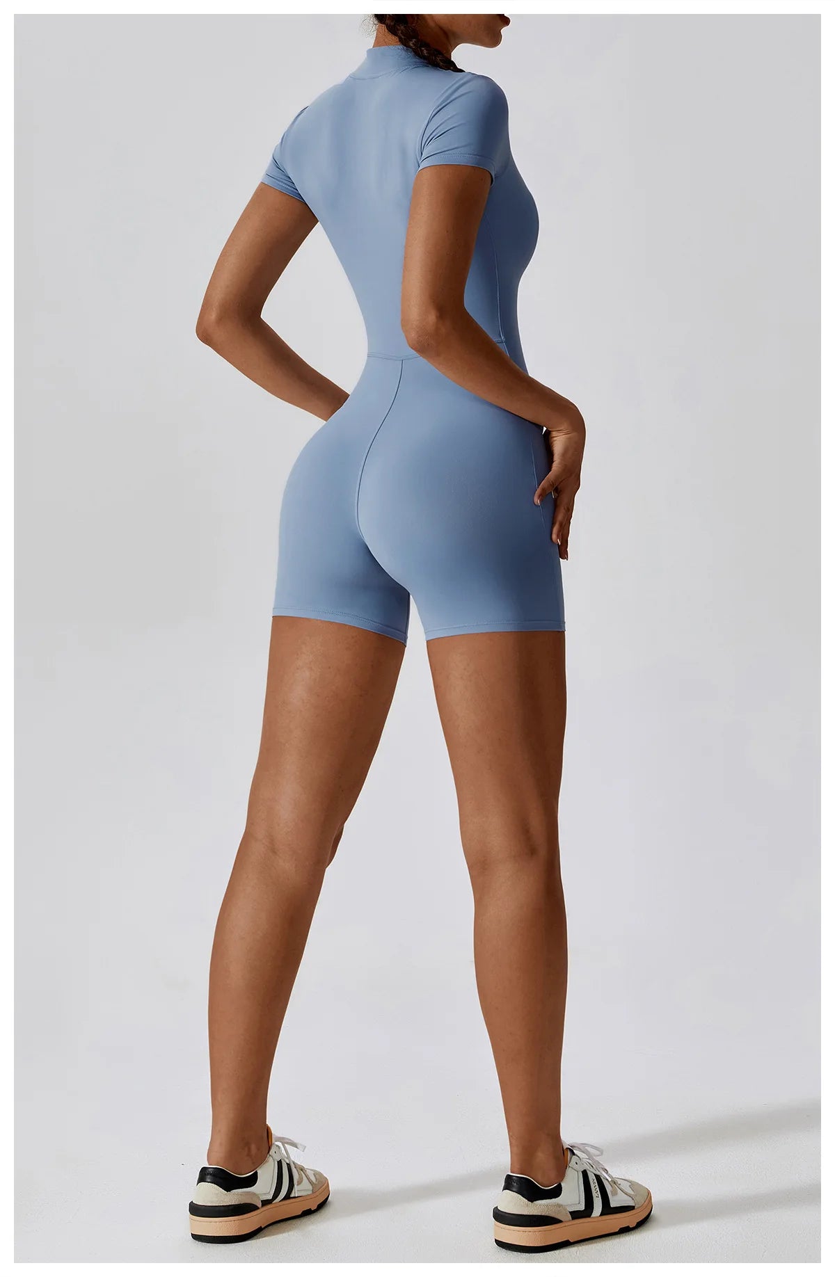 Person wearing a blue bodysuit on a white background