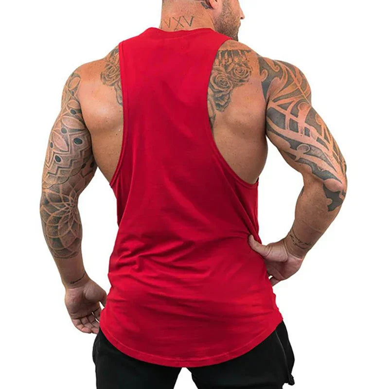 Man wearing a red tank top with tattoos on arms and back, on a white background