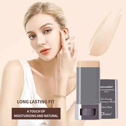 Woman applying concealer stick with product packaging on a beige background