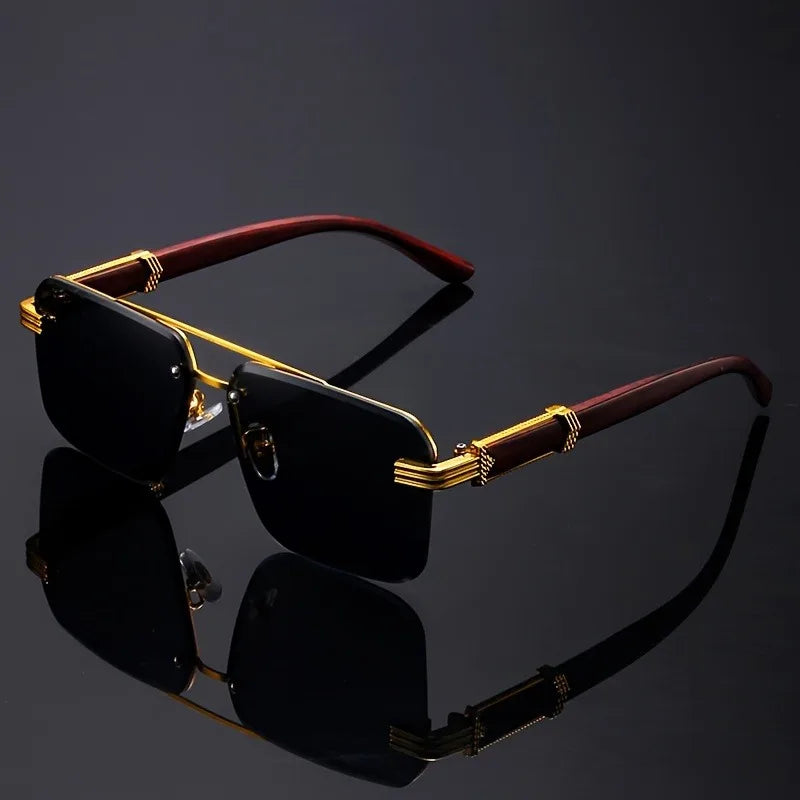 Sunglasses with gold and red frame on a reflective black surface