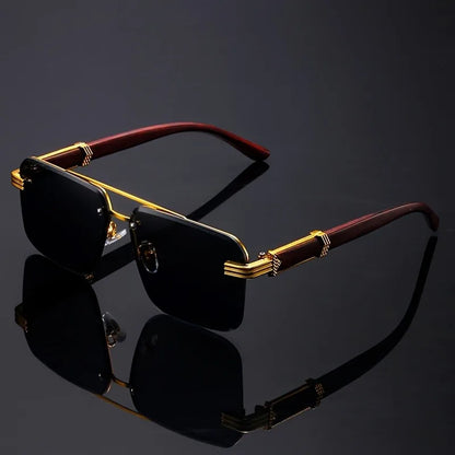 Sunglasses with gold and red frame on a reflective black surface