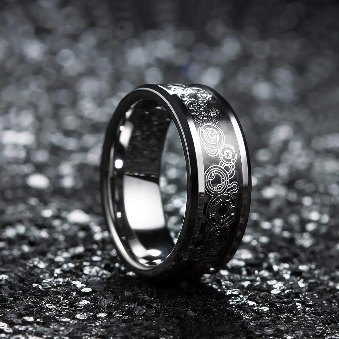 Silver ring with intricate designs on a dark textured background