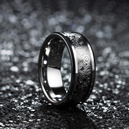 Silver ring with intricate designs on a dark textured background