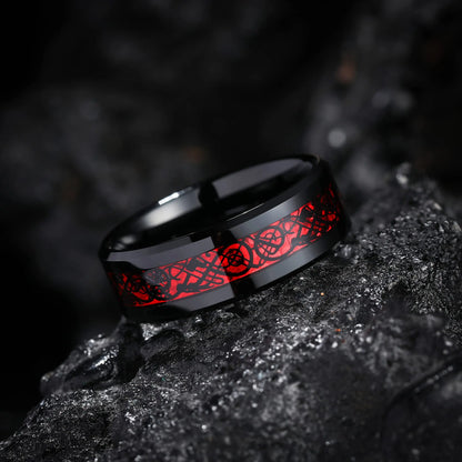 Black ring with red floral design on a dark textured surface