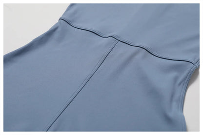 Close-up of a blue sleeveless top on a light gray background