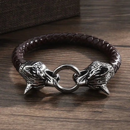 Bracelet with wolf head designs on a wooden surface