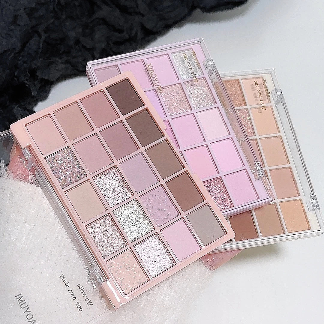 Makeup palettes with a variety of colors on a light background