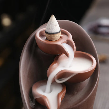 Ceramic incense burner with incense cones on a blurred background
