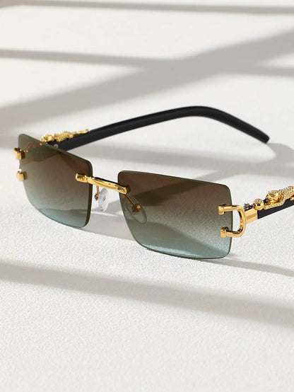 Gold-framed sunglasses with gradient lenses on a light background