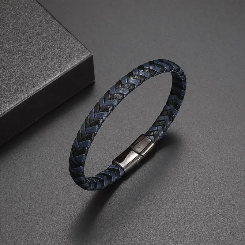 Black braided leather bracelet with a metal clasp on a gray background