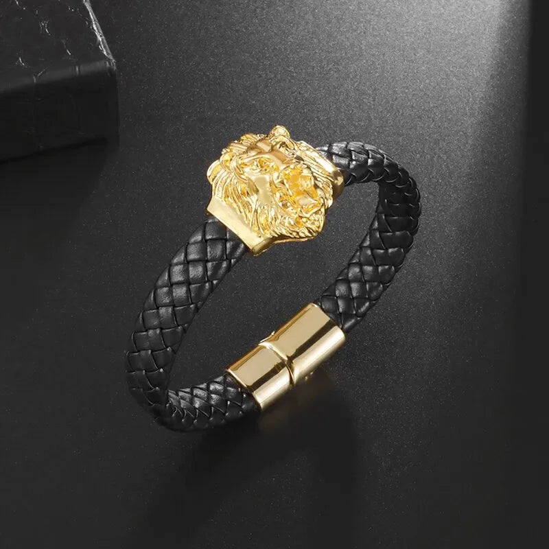Black braided leather bracelet with gold lion head clasp on a dark background