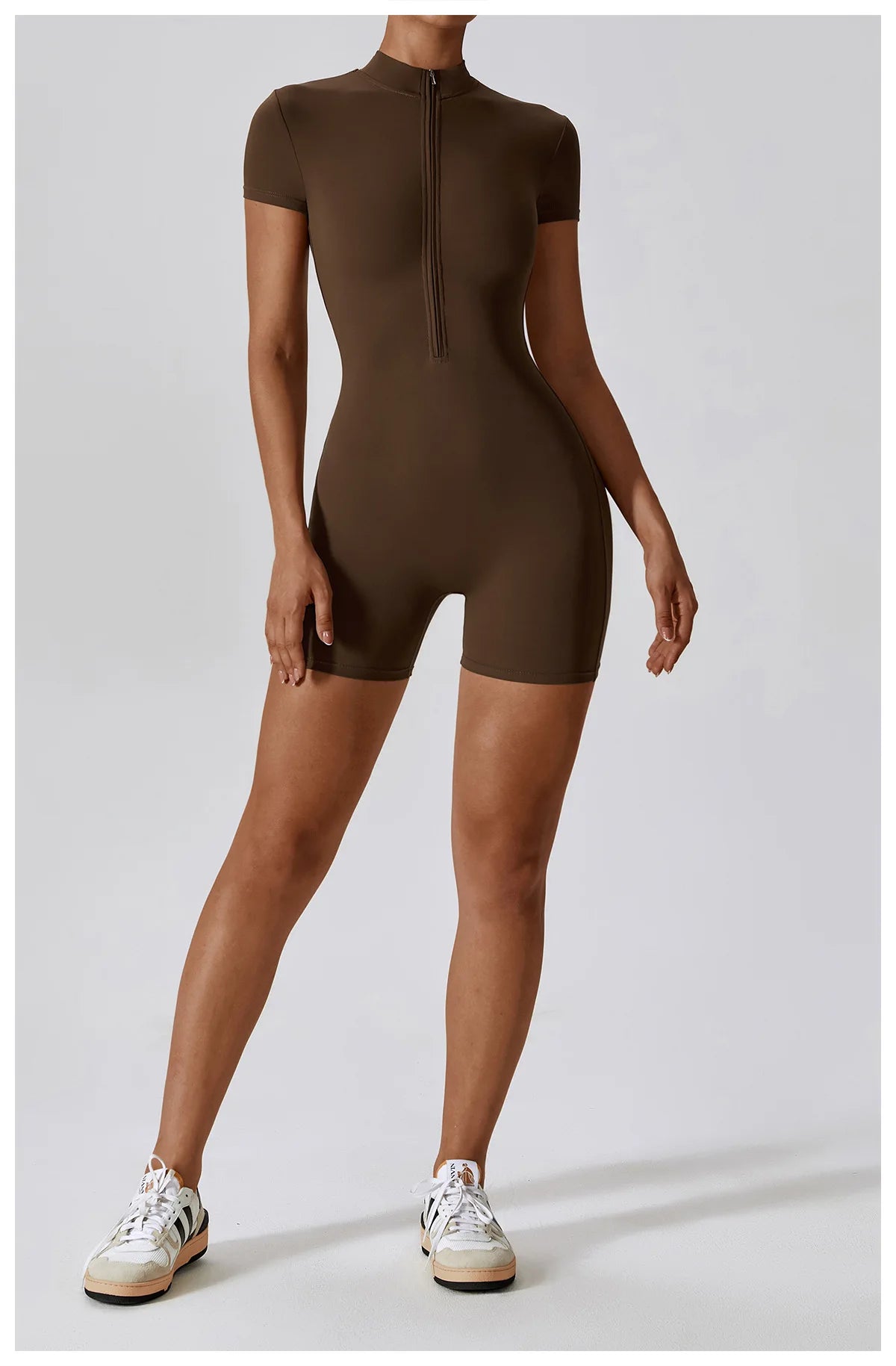 Person wearing a brown bodysuit on a white background