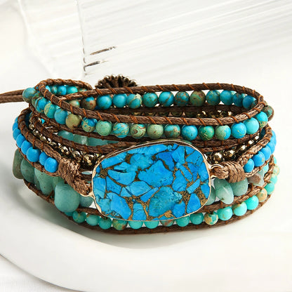 Turquoise beaded bracelet with a large turquoise stone on a white background