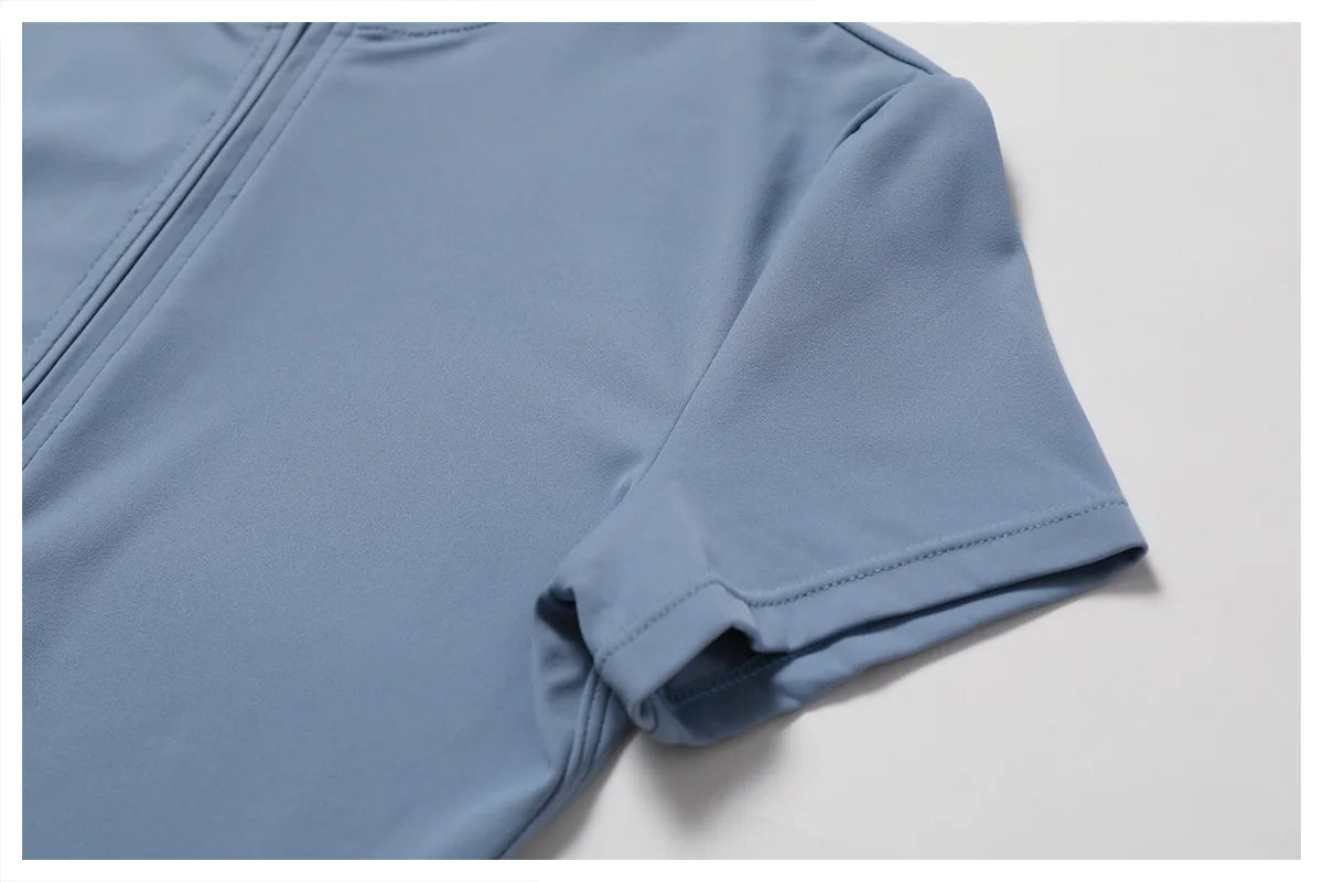 Close-up of a blue garment with a zipper on a light gray background