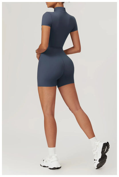 Person wearing a navy blue bodysuit on a light gray background