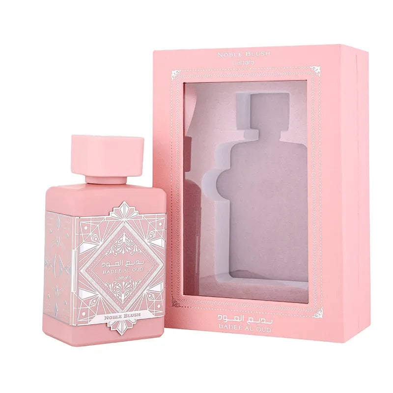 Pink perfume bottle with decorative design and matching pink packaging on a white background