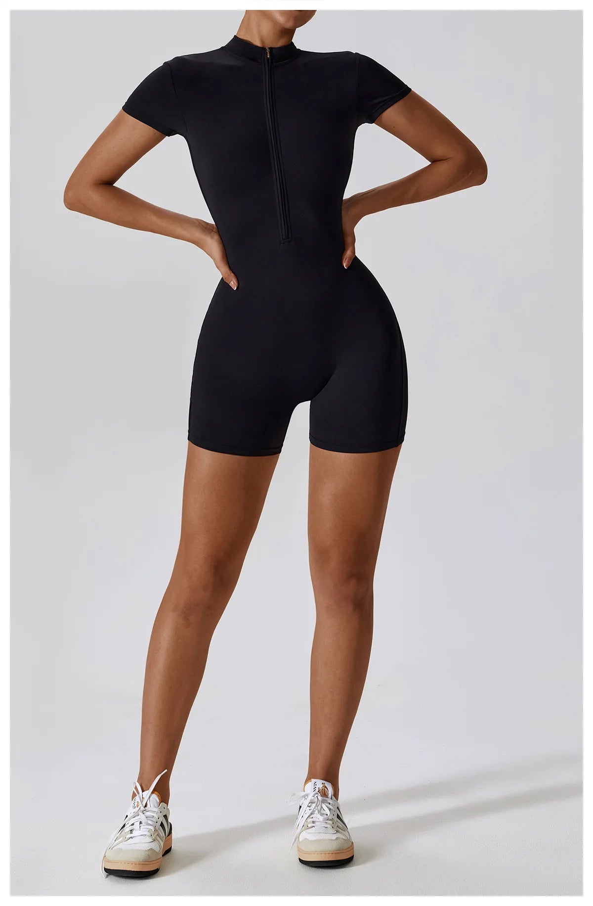 Person wearing a black bodysuit on a white background