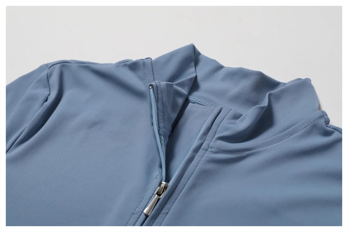 Close-up of a blue jacket with a zipper on a light gray background
