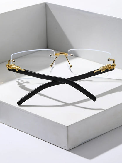 Two pairs of eyeglasses with gold and black frames on a white surface.
