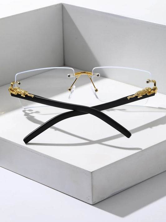 Two pairs of eyeglasses with gold and black frames on a white surface.