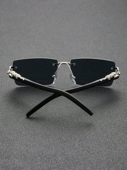 Black sunglasses with decorative metal accents on a gray background
