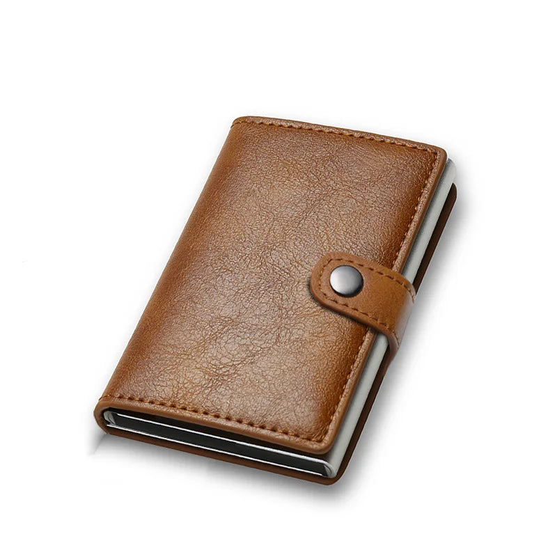 Brown leather cardholder with metal accents on a white background