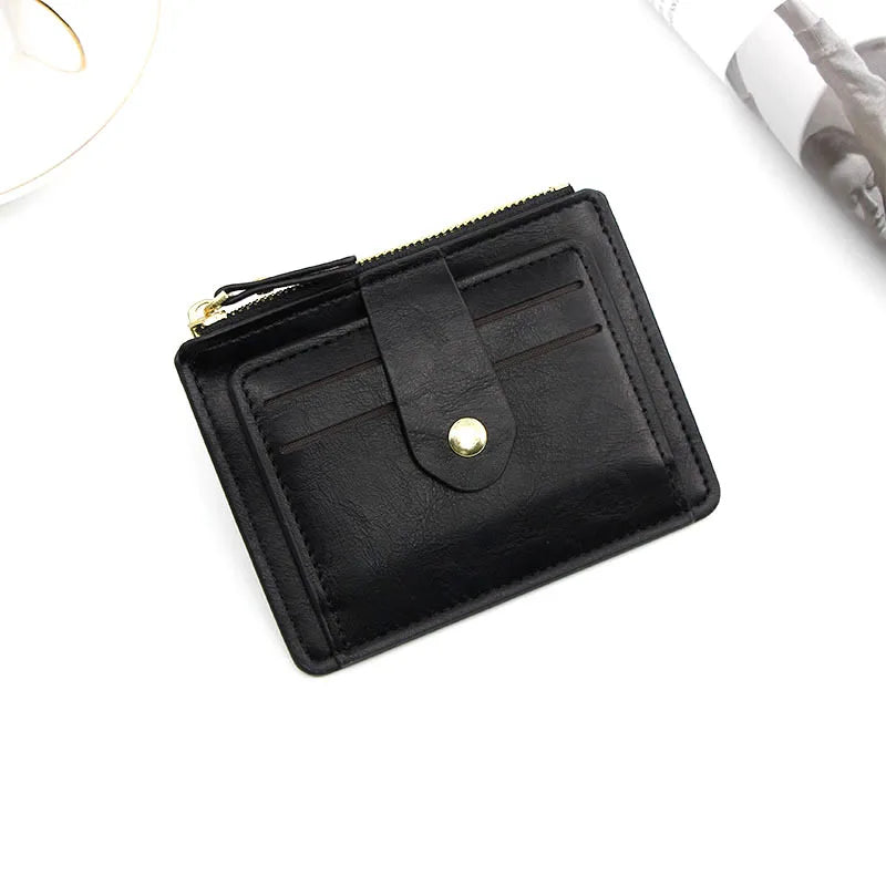 Black wallet with a gold buckle on a white background