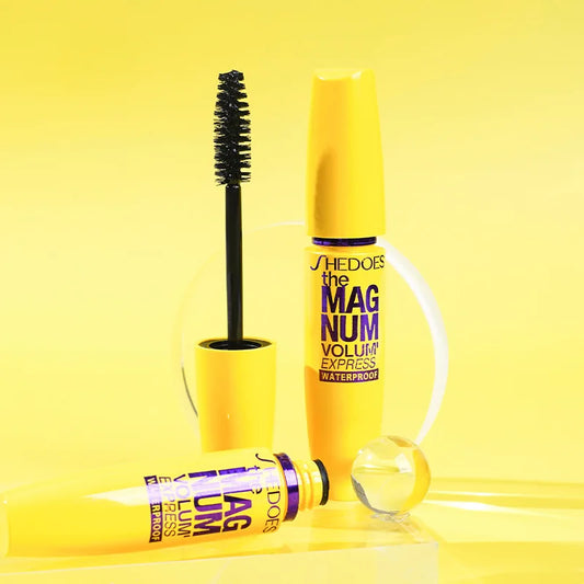 Shiseido Magnum Volume Express mascara on a yellow background