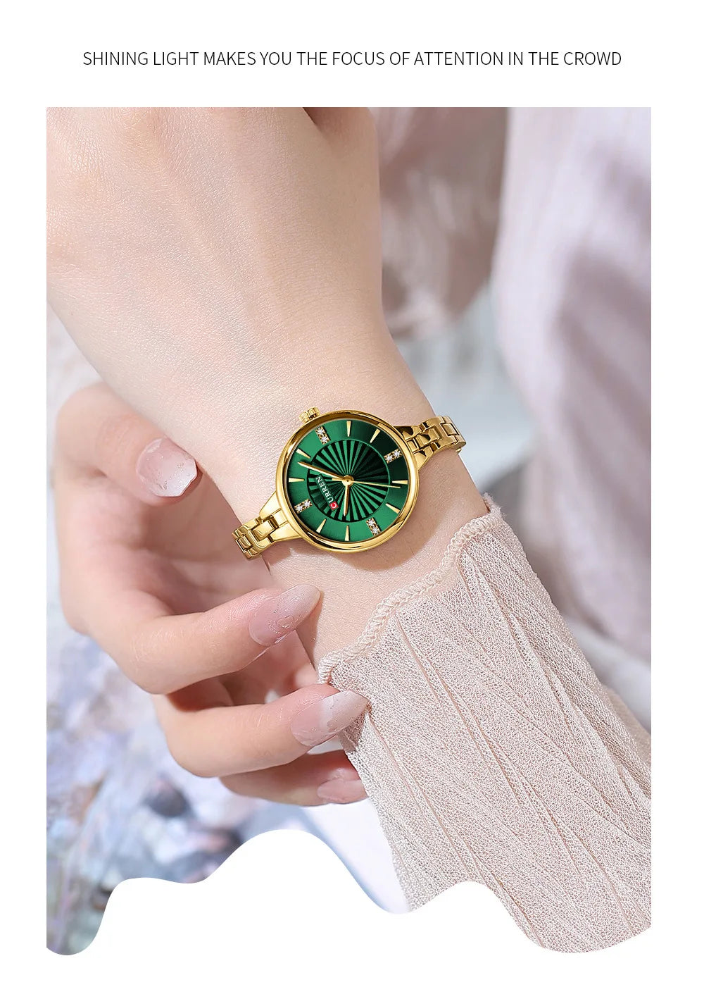 Hand wearing a gold watch with a green face on a blurred background