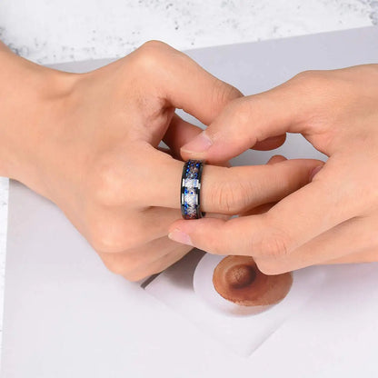 Close-up of two hands with a ring featuring blue stones on a white background