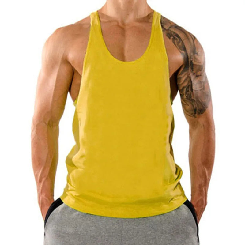 Person wearing a yellow tank top and gray shorts on a white background