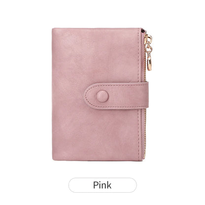 Pink wallet with a gold zipper on a white background