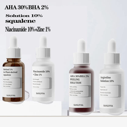 Four skincare serum bottles with labels on a light gray background