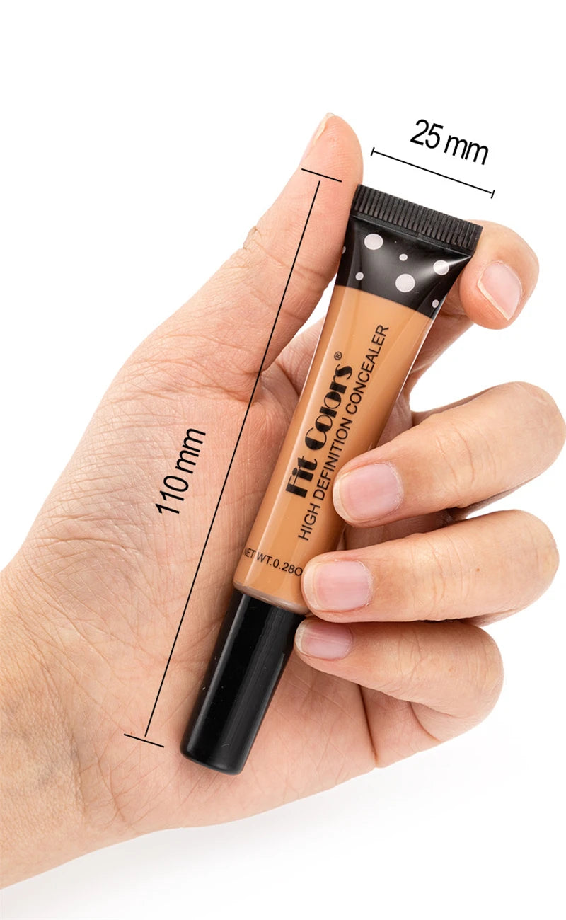 Hand holding a tube of concealer with measurements indicated