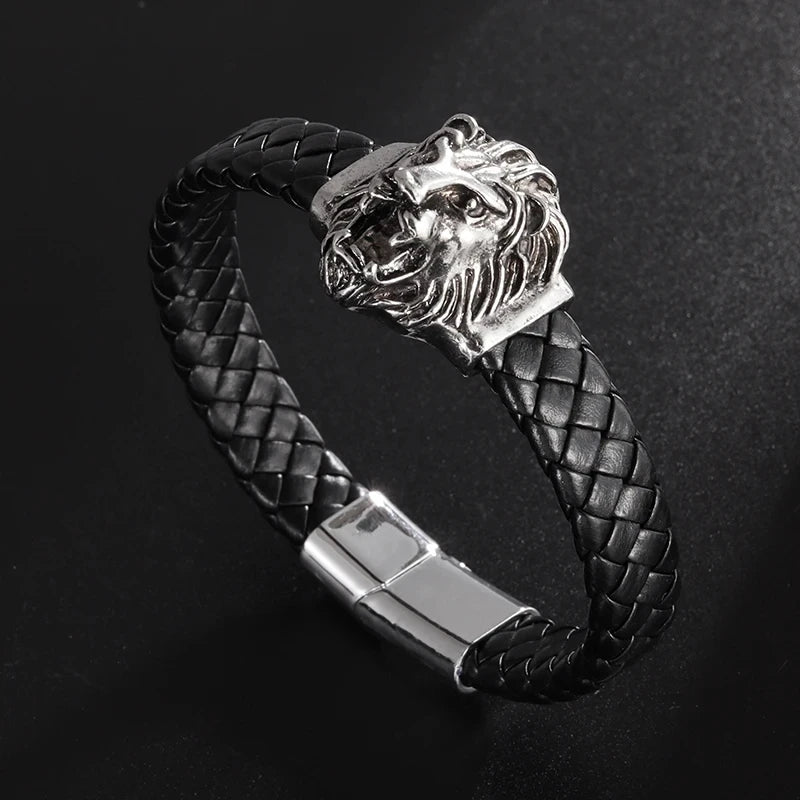 Black braided leather bracelet with silver lion head clasp on a dark background
