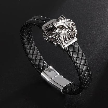 Black braided leather bracelet with silver lion head clasp on a dark background