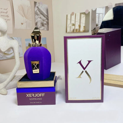 Purple perfume bottle with gold cap on a Xerjoff box, surrounded by decorative items.