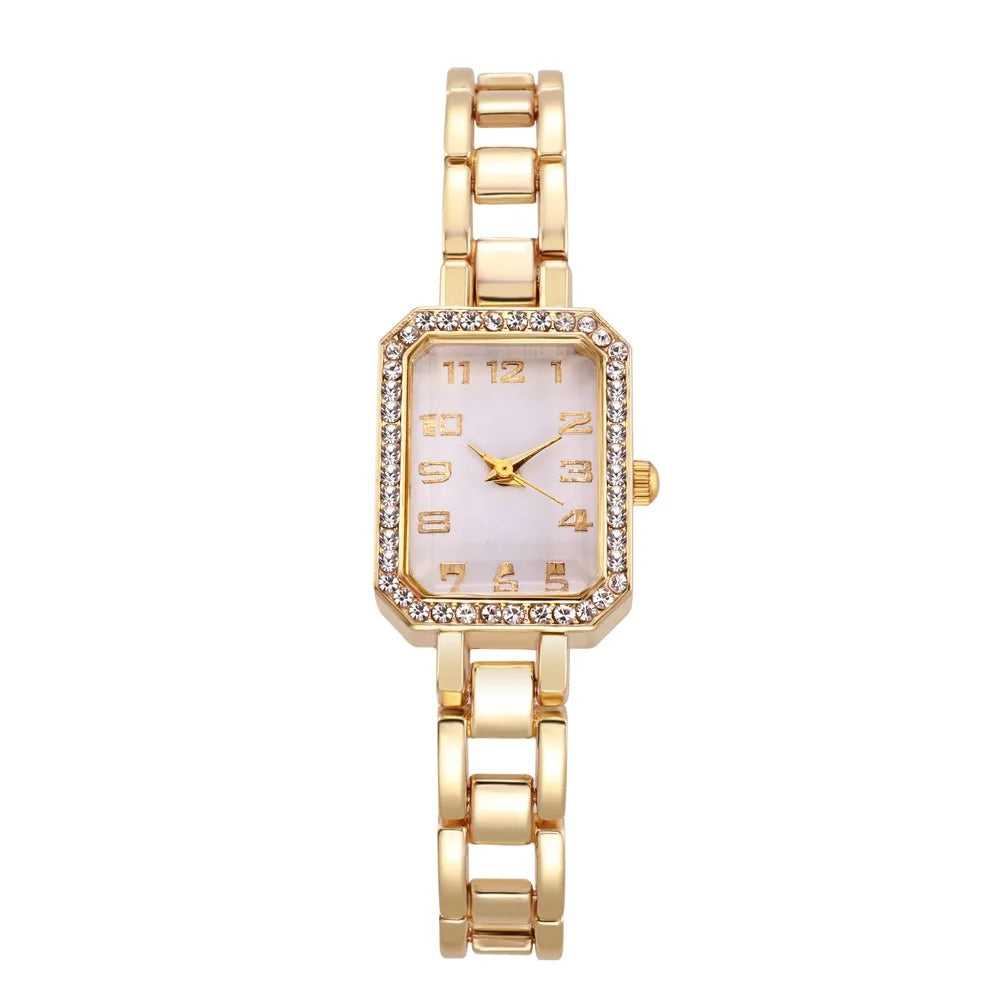 Gold wristwatch with a white face on a white background