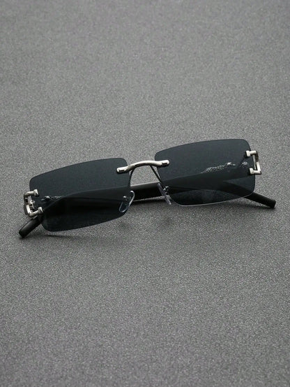 Sunglasses with thin frames and dark lenses on a gray surface