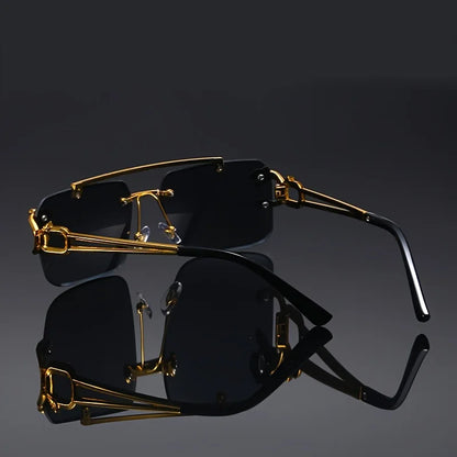 Black sunglasses with gold frames on a reflective black surface