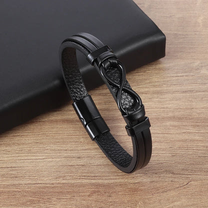 Black leather bracelet with an infinity symbol on a wooden surface
