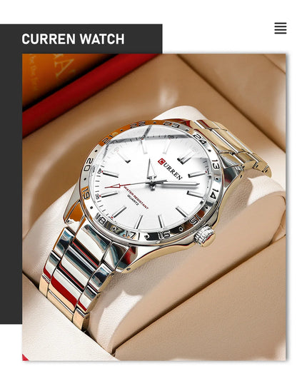 Silver watch with a white face on a beige surface, branded 'CURREN'.
