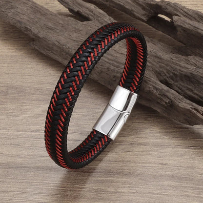 Black and red braided bracelet with a silver clasp on a wooden surface