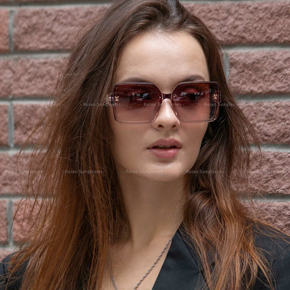 Woman wearing sunglasses with a brick wall background