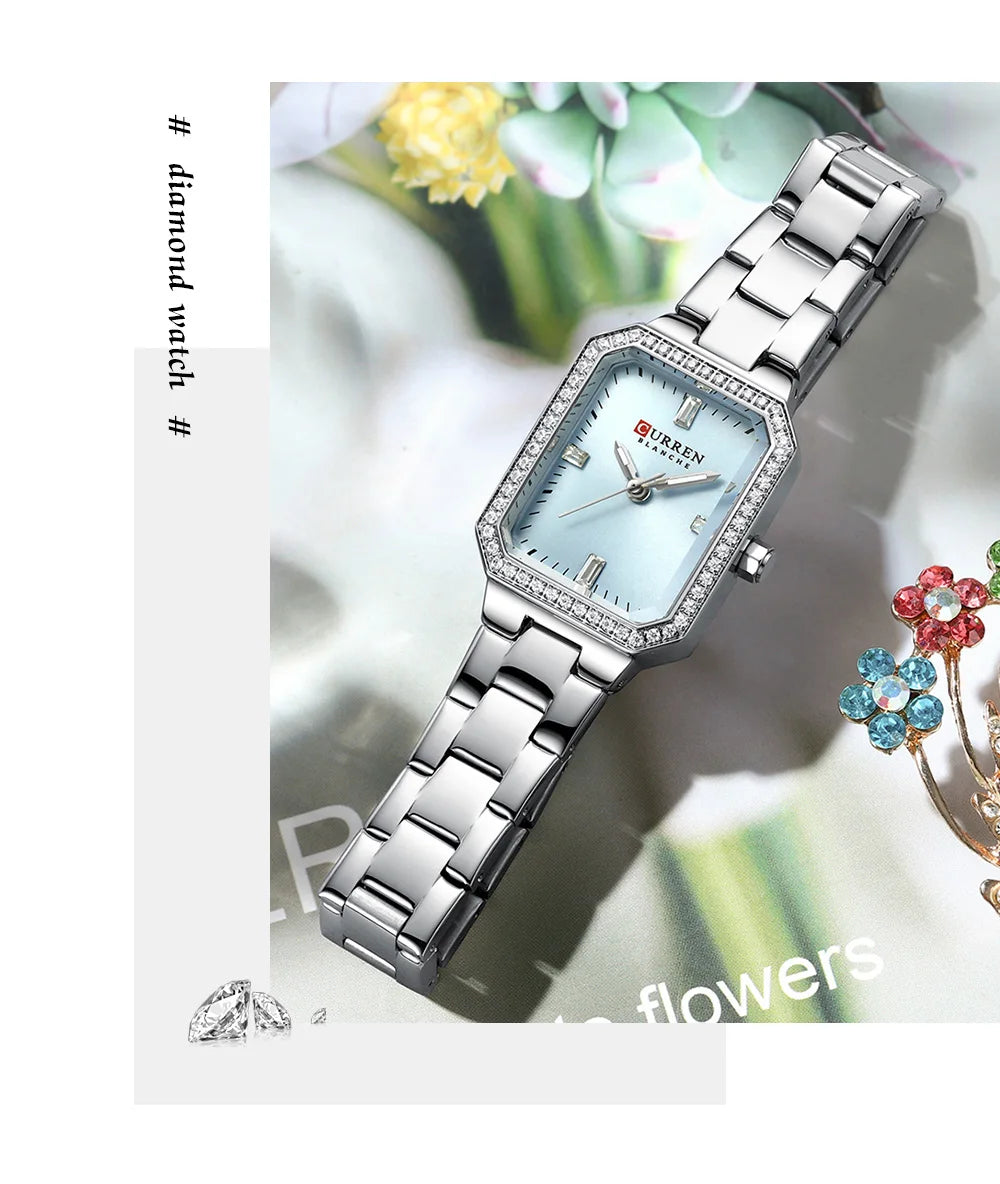 Silver wristwatch with a light blue face on a white background with floral elements.