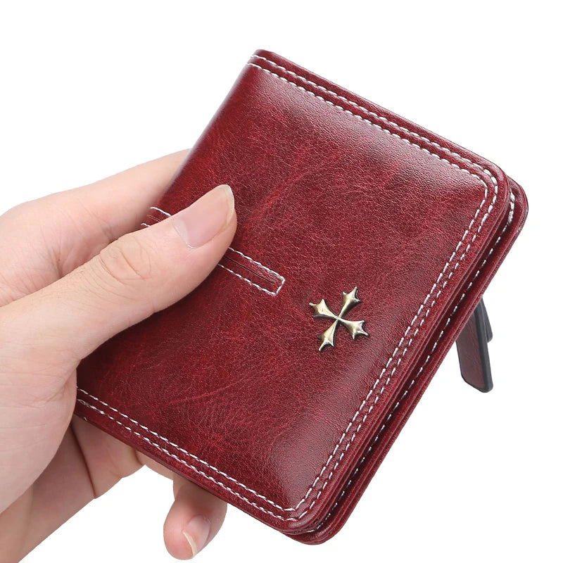 Red wallet with a cross emblem held by a hand on a white background