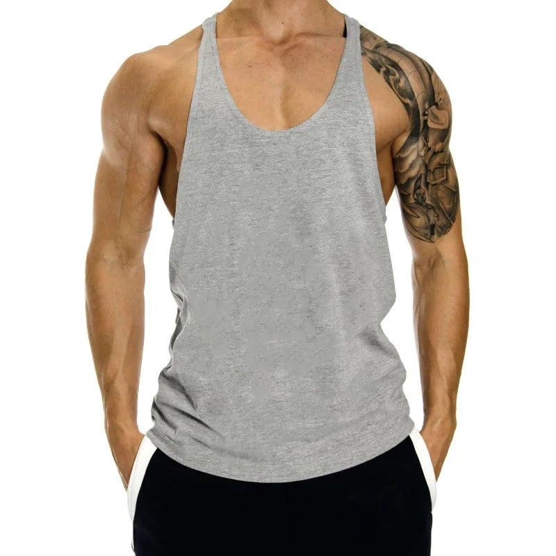 Person wearing a gray tank top with a white background
