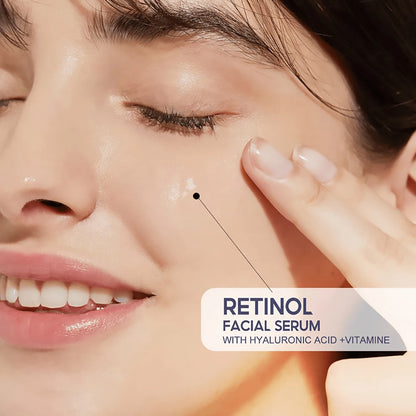 Close-up of a person applying retinol facial serum to their face with a focus on the product label.