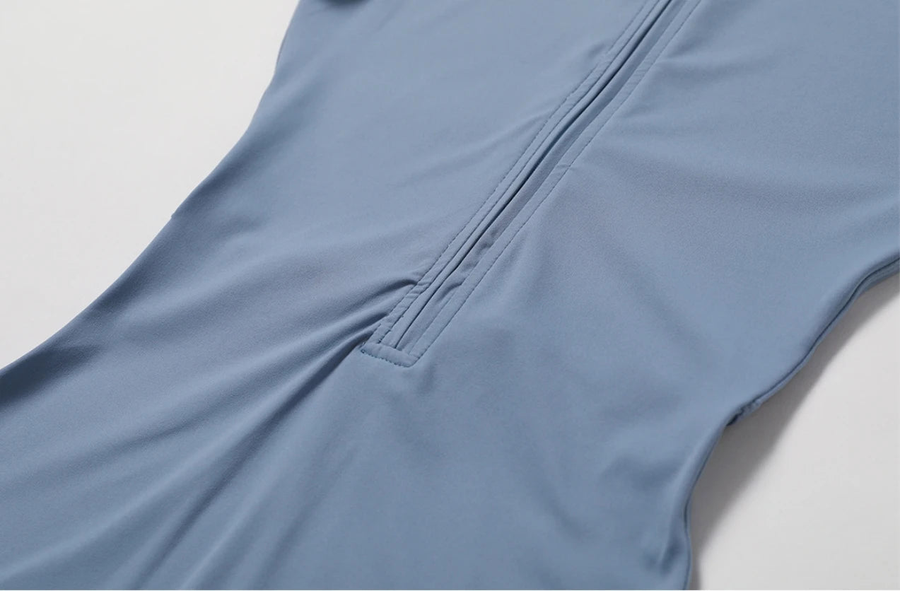 Close-up of a blue garment with a zipper on a light gray background