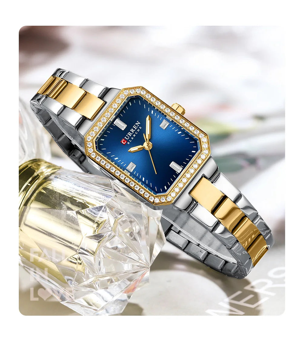 Two-tone watch with blue dial and gold accents on a blurred background